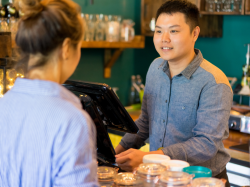 Man working behind counter at cafe